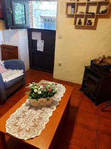 a living room with a table with a pot of flowers on it at Casa del Águila del Valle in Riópar Viejo +3 photos
