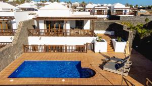 an image of a house with a swimming pool at Villa DaVinci - Playa Blanca in Playa Blanca