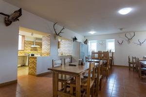 a kitchen and dining room with a table and chairs at Penzion Hlinky in Hlinky