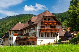 una casa grande con flores en las ventanas en Gasthaus Rebstock, en Simonswald
