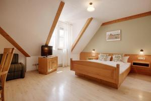 a bedroom with a bed and a television in it at Landhotel Schwab - by homekeepers in Schwarzach am Main