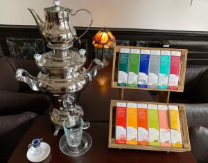 a silver trophy sitting on top of a table with books at Hôtel Vintage in Quimperlé
