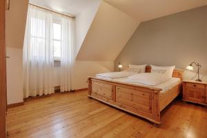a bedroom with a large wooden bed and a window at Ferienhaus Schwab - Sauna, eigene Terrasse, 3 Schlafzimmer - by homekeepers in Schwarzach am Main