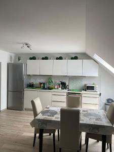 a kitchen with a table and chairs in a kitchen at Apartment 28 in Stadthagen