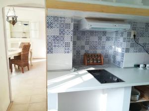 a kitchen with a white counter top and a table at Nerezine apartmany CENTRUM in Nerezine