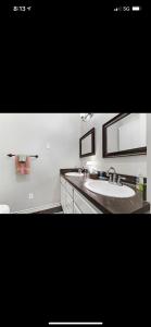 a bathroom with a sink and a mirror at Little House on the Corner in Livingston