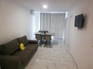 a living room with a couch and a table at Venezia Apartman in Veliko Gradište