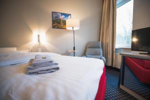 Ein Bett oder Betten in einem Zimmer der Unterkunft Hotel in Herrenhausen