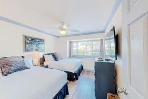 a bedroom with two beds and a window at Costa Del Sol C1- Scenic Sands in Destin