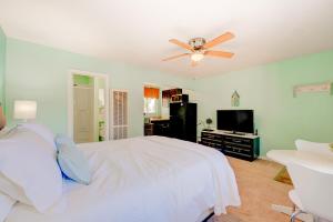 a bedroom with a white bed and a ceiling fan at Pine Tree Place - Unit 3 in South Lake Tahoe