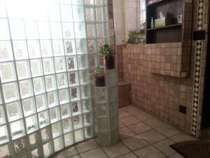 a tiled bathroom with two potted plants in it at Ray's Bucktown Bed and Breakfast in Chicago