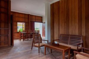 a living room with wooden walls and wooden chairs at Beyond Angkor Homestay - Private Floor 2-Bedroom & Living Room in Siem Reap