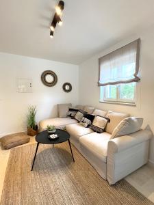 a living room with a white couch and a table at Villa Meliora in Vižinada