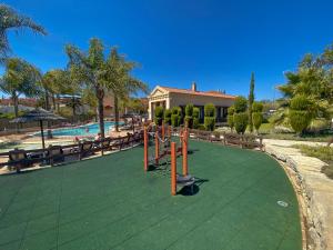 a playground in front of a swimming pool at Baia da Luz - Nuzone Apartment in Luz