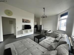 a living room with a couch and a tv at Apartment in Solingen Ohligs in Solingen