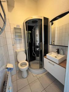 a bathroom with a shower and a toilet and a sink at Apartment in Solingen Ohligs in Solingen