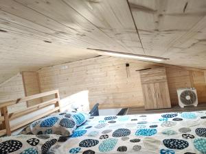 a bedroom with a bed in a wooden room at Petit Coin de Bonheur studio Neuf et lumineux à 5mins du Centre-ville in La Mure