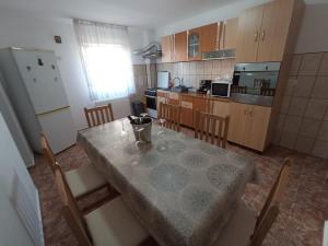 a kitchen with a table and chairs and a refrigerator at CASA VIO in Cristian