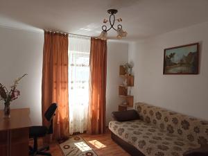 a living room with a couch and a window at CASA VIO in Cristian