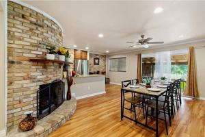 a living room with a brick fireplace and a table with chairs at Yellow Stone: Chef's Kitchen, Patio & Location in San Antonio