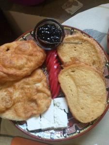 a plate of food with pies and jam on it at Guest House Markovi in Govedartsi