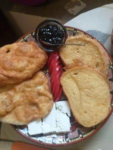 a plate of food with pies and jam on it at Guest House Markovi in Govedartsi +106 photos