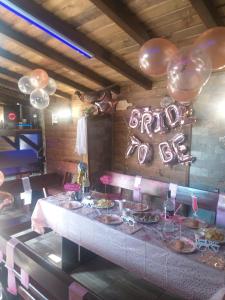 una mesa con platos de comida y globos en Guest House Markovi en Govedartsi