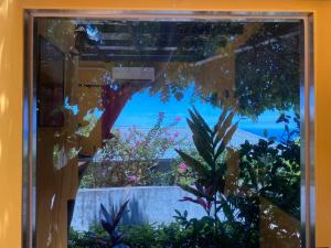 una ventana con vistas al océano desde un jardín en Dosun B&B, en Jiufen