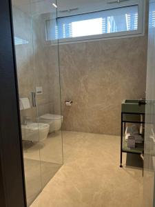a bathroom with a glass shower and a toilet at Ceccarini 9 home suite home in Riccione
