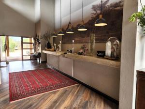 a kitchen with a red rug on the floor at Karongwe Portfolio - Becks Safari Lodge in Karongwe Game Reserve