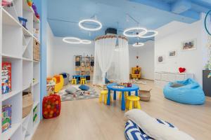 a childs play room with a table and chairs at Dukley Hotel & Resort in Budva