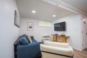 a living room with a blue couch and a tv at Edelweiss Haus M3 in Park City