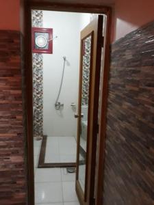 Habitación con baño con ducha y espejo. en Dany ka, en Naj‘ al Maḩaţţah