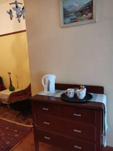 a dresser in a room with two cups on it at Die Blom in Krugersdorp