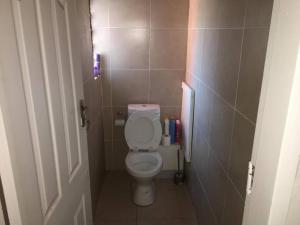 a small bathroom with a toilet in a stall at Specious Old Zamtel flats in Lusaka