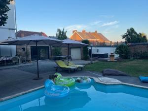 a swimming pool with some toys in a backyard at Tournez La Page in Erquelinnes