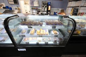 a display case in a bakery with many different pastries at Aurora Borealis in Saint Ignace