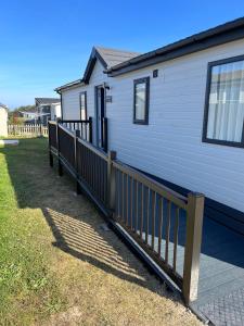 a house with a wooden fence in front of it at Beach Base Lodge, Padstow Cornwall in Padstow