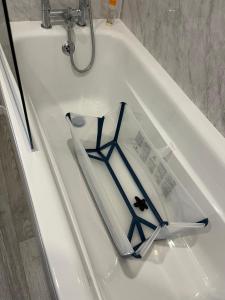 a book sitting on top of a white bath tub at Beach Base Lodge, Padstow Cornwall in Padstow