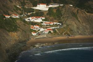 a group of houses on a hill next to a beach at Casa Amado, Aldeia da Pedralva in Vila do Bispo +47 photos