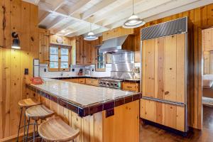 a large kitchen with wooden cabinets and a counter top at Hideaway Pines in Lake Arrowhead