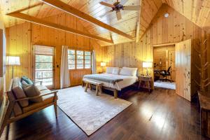 a bedroom with a bed in a room with wooden walls at Hideaway Pines in Lake Arrowhead
