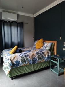 a bedroom with a bed with a bedspread with animals on it at Dreamers nest in Richards Bay