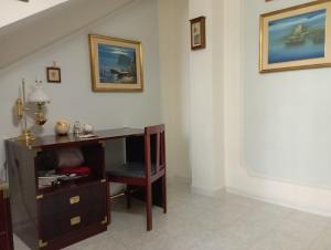 a staircase with a desk and a chair in a room at Domus Garden in Olbia