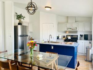 a kitchen with a glass table with a vase of flowers at Death Valley Hot Springs 3 Bedroom in Tecopa