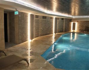 a large swimming pool with lights in a building at BENESTA BEYOGLU in Istanbul