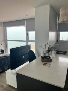 a kitchen with a white counter top in a room at Dpto con vista increible 102 in Mar del Plata