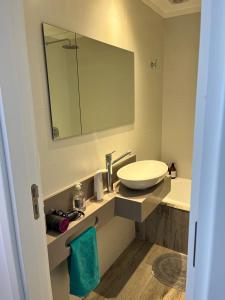 a bathroom with a sink and a mirror at Dpto con vista increible 102 in Mar del Plata