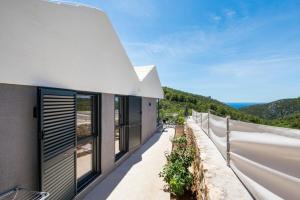 a house with a balcony with a view at Rural house Pikola with sea view on Vis Island in Komiža