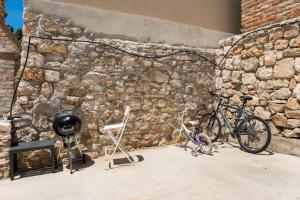 a bike parked next to a stone wall at Rural house Pikola with sea view on Vis Island in Komiža